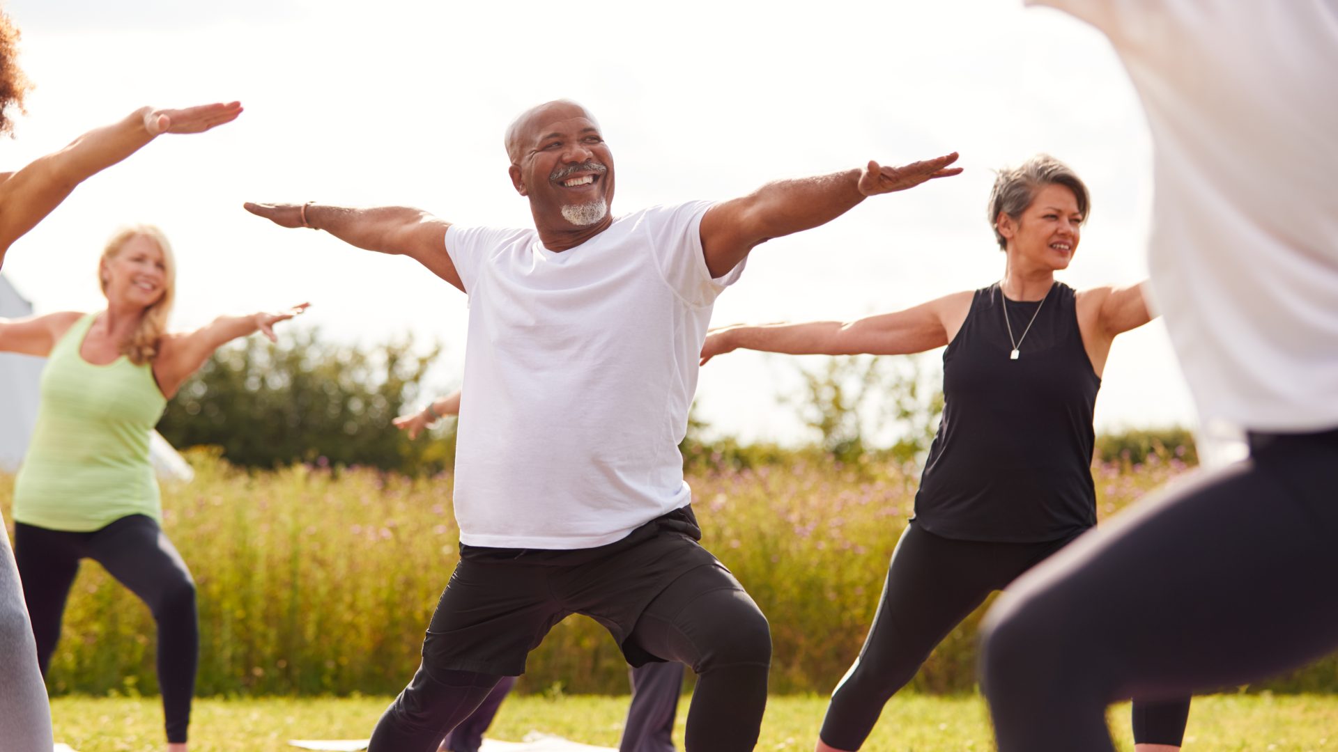 a group of people doing yoga in a field at The Hudson Oaks