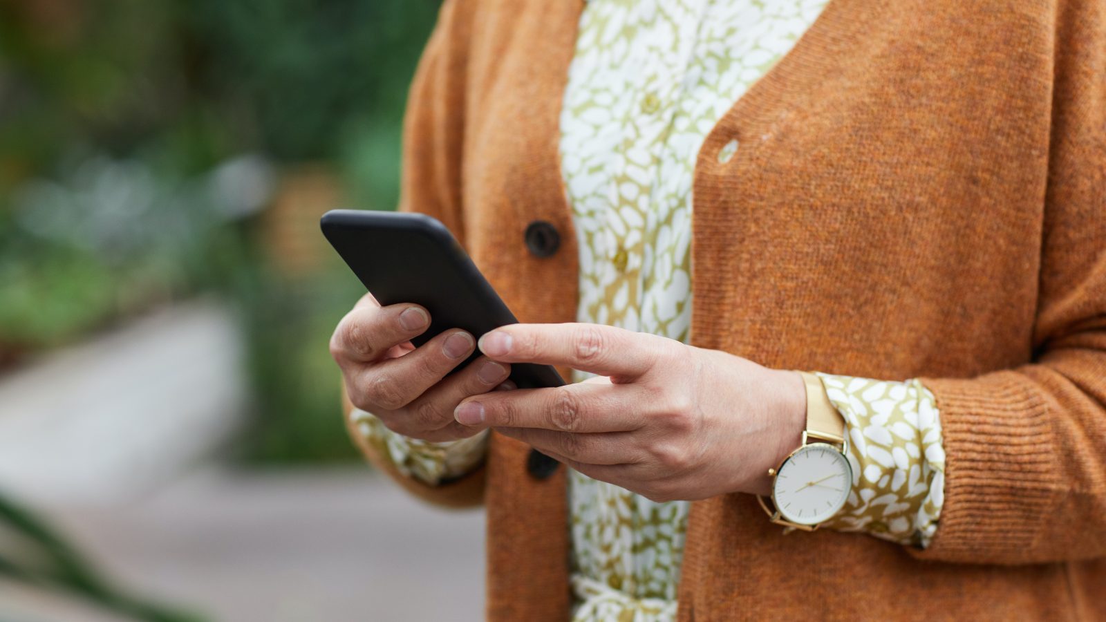 a woman holding a cell phone in her hand at The Hudson Oaks